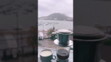 Ice coffee on a rainy afternoon overviewing the beach 🏖 and cloudy moutain 🏔